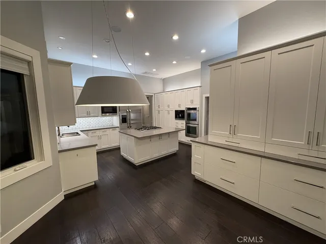a kitchen with a stove and white cabinets