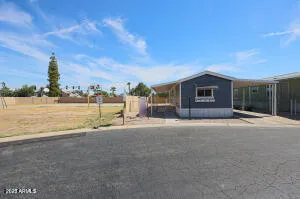 a view of a house with a yard and lake view