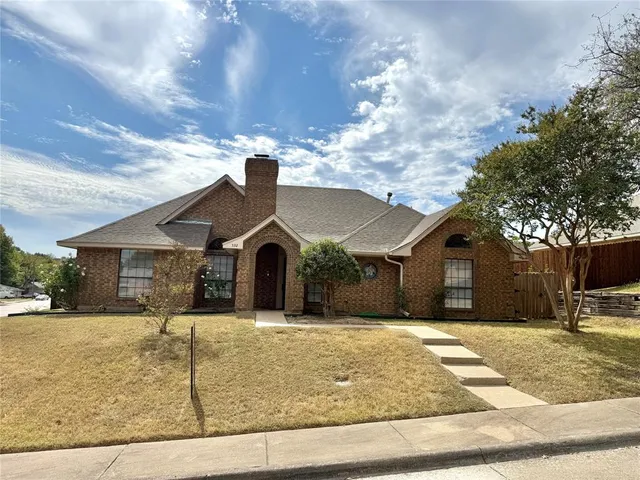 a front view of a house with a yard covered with snow