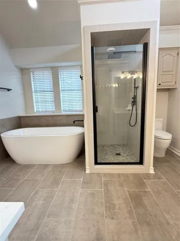 a bathroom with a bathtub and shower