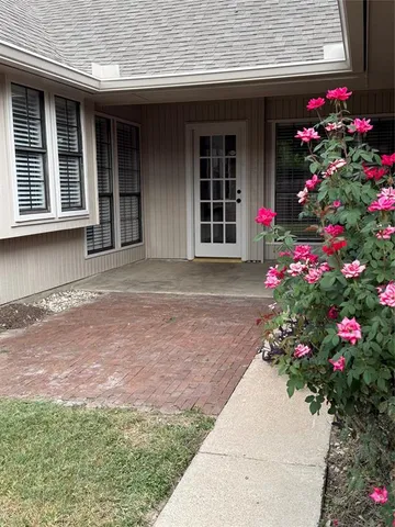 a flower garden is sitting in front of a house