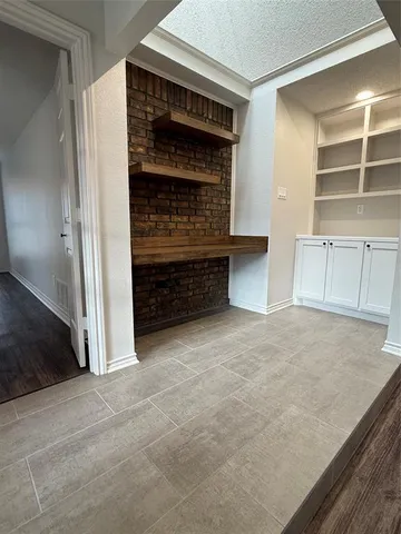 a view of an empty room and a window