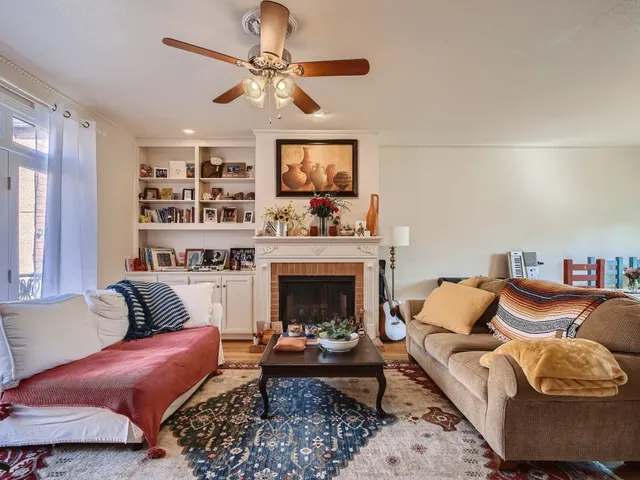 a living room with furniture and a fireplace