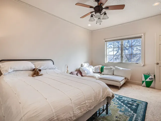 a bedroom with double bed and a window