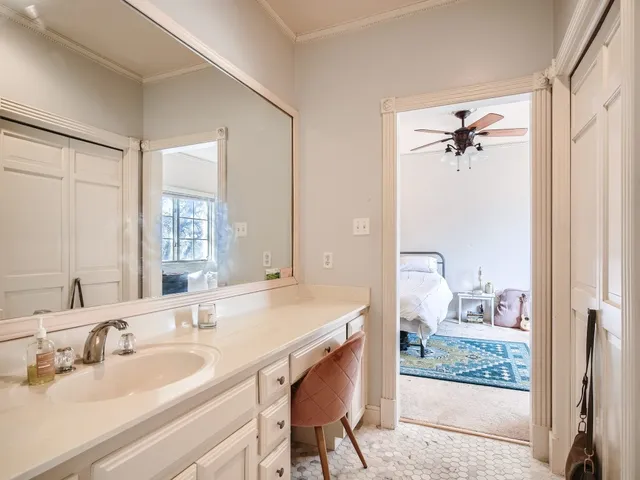 a en suite bathroom with a sink double vanity and a mirror
