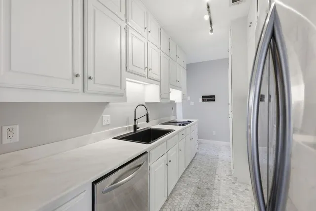 a kitchen with a sink and cabinets