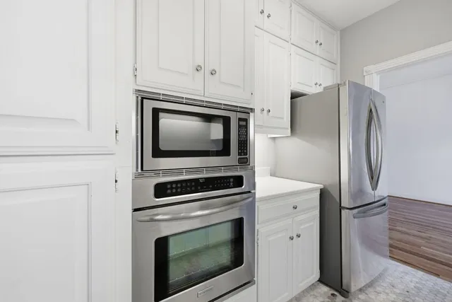 a kitchen with a stove and a white cabinet