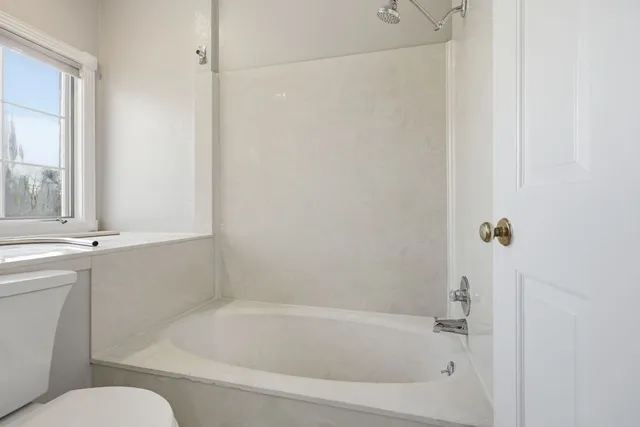a bathroom with a granite countertop sink a mirror and a shower