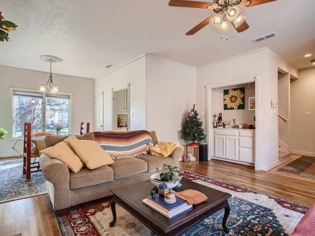a living room with furniture and wooden floor