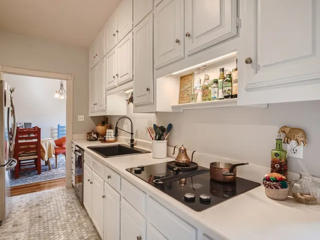 a kitchen with sink stove and cabinets