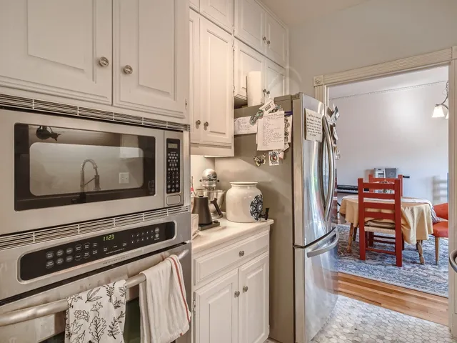 a kitchen with stainless steel appliances granite countertop a refrigerator and a stove top oven