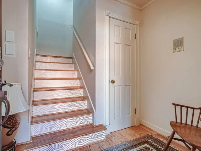 a view of a hallway with wooden floor and entryway