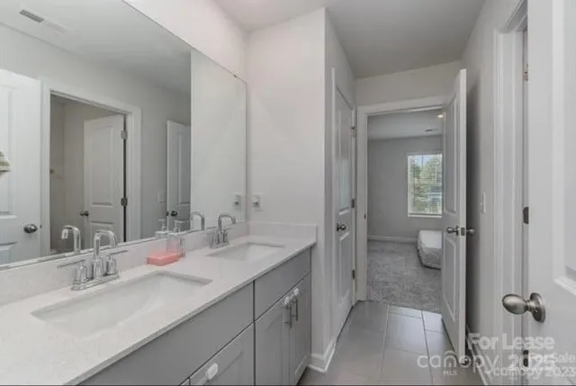 a bathroom with a granite countertop sink mirror and a toilet
