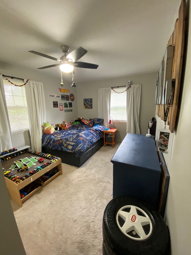 1902 Crescent Drive Champaign, IL 61821 - Photo 11 of 24 a bedroom with bed and a chandelier