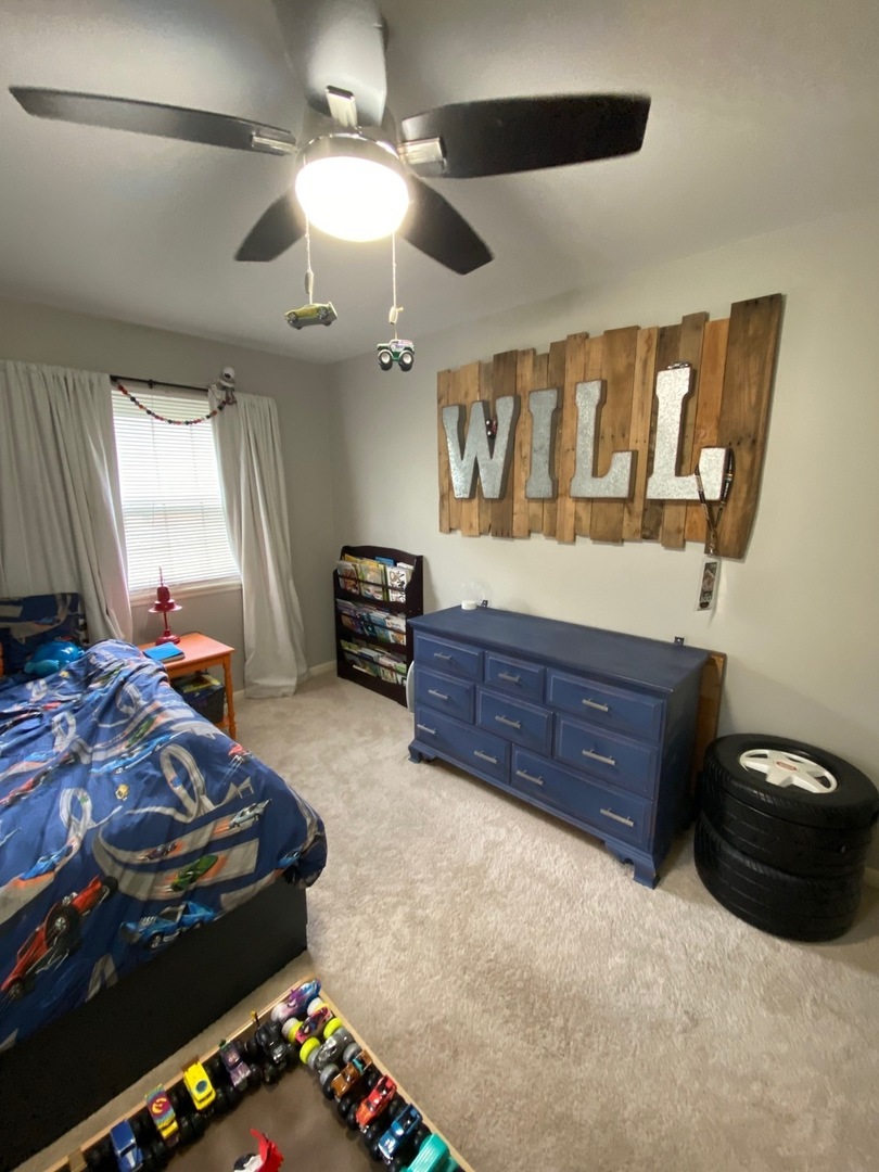 1902 Crescent Drive Champaign, IL 61821 - Photo 12 of 24 a bedroom with a bed and a ceiling fan