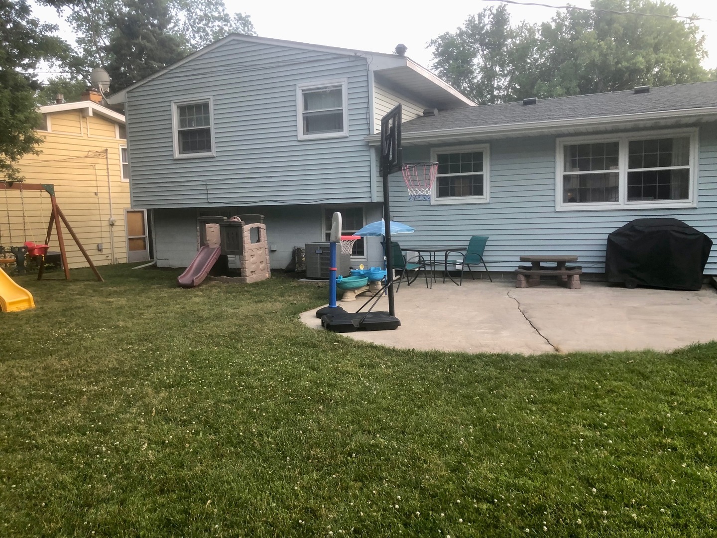 1902 Crescent Drive Champaign, IL 61821 - Photo 24 of 24 a view of a house with a patio and a yard