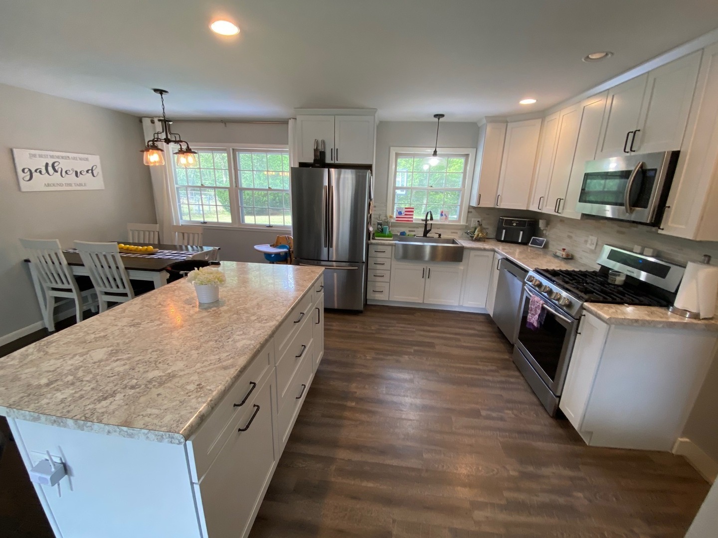 1902 Crescent Drive Champaign, IL 61821 - Photo 4 of 24 a large kitchen with stainless steel appliances granite countertop a large counter top a stove a chimney a sink and a refrigerator