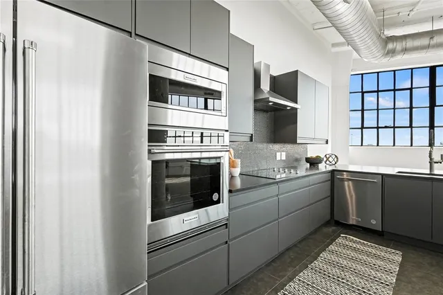 a kitchen with stainless steel appliances granite countertop a stove and a sink