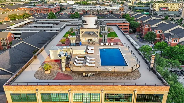 an aerial view of a house with outdoor seating