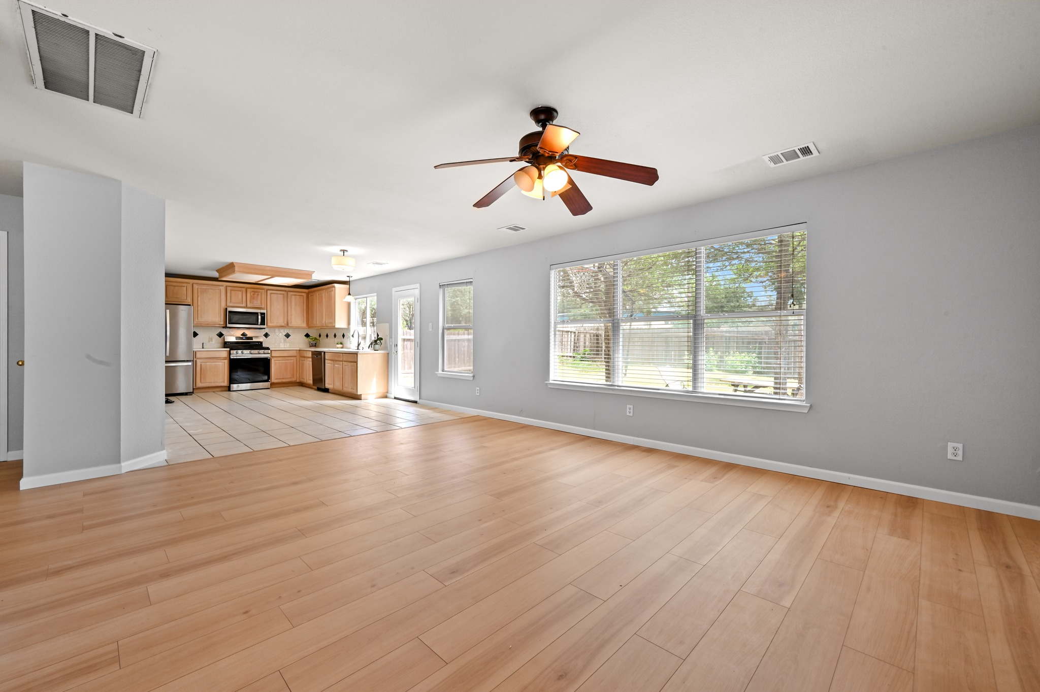 2700 Cradlerock Terrace Austin, TX 78748 - Photo 11 of 29 a view of a livingroom with hardwood floor and a ceiling fan