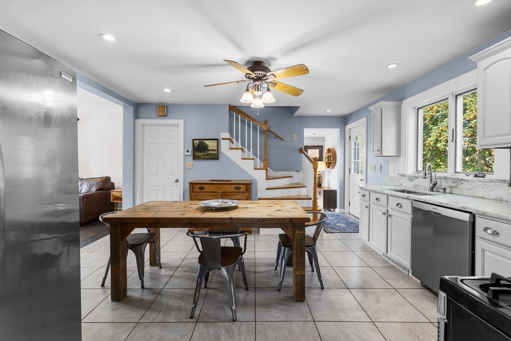 11 Saucier Street Acushnet, MA 02743 - Photo 11 of 35 a kitchen with stainless steel appliances granite countertop table chairs sink and cabinets