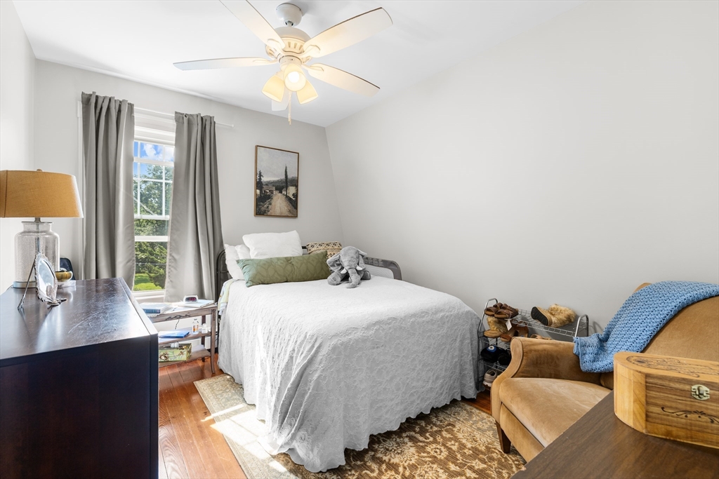 11 Saucier Street Acushnet, MA 02743 - Photo 21 of 35 a bedroom with a bed and wooden floor