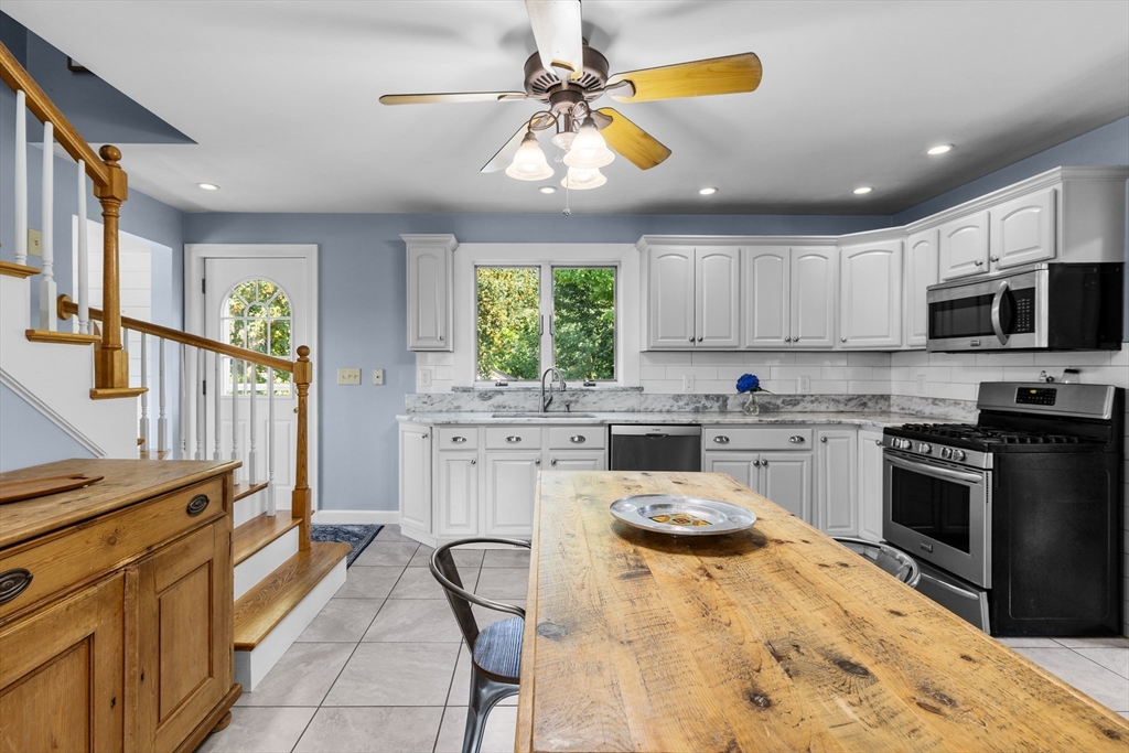 11 Saucier Street Acushnet, MA 02743 - Photo 8 of 35 a kitchen with a stove a sink and a microwave