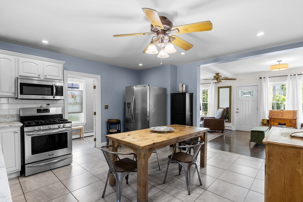 11 Saucier Street Acushnet, MA 02743 - Photo 9 of 35 a kitchen with stainless steel appliances kitchen island granite countertop a refrigerator a stove top oven a sink with island and chairs