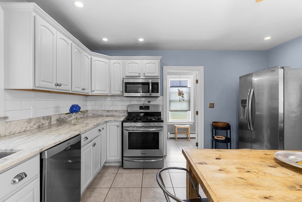 11 Saucier Street Acushnet, MA 02743 - Photo 10 of 35 a kitchen with stainless steel appliances kitchen island granite countertop a stove sink and refrigerator
