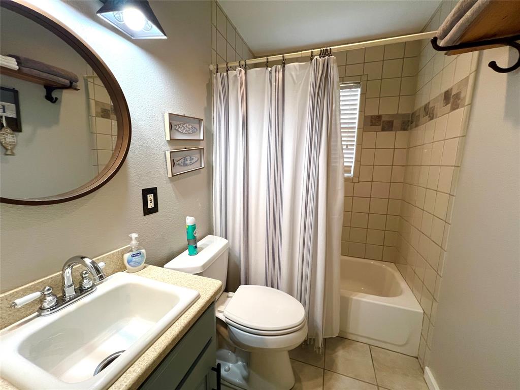 1957 Deer Trail Road Graford, TX 76449 - Photo 22 of 32 a bathroom with a sink toilet and shower