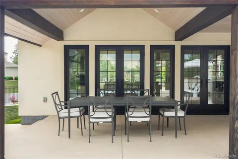 a view of a dining room with furniture large windows and wooden floor