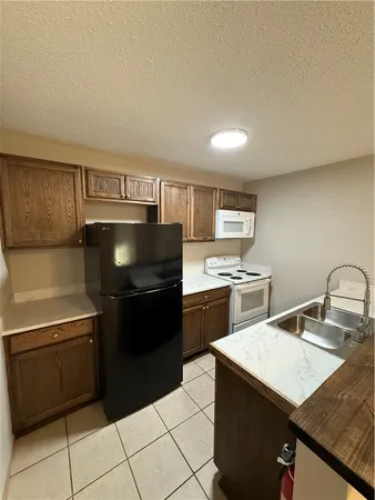 a kitchen with a stove a sink and a refrigerator