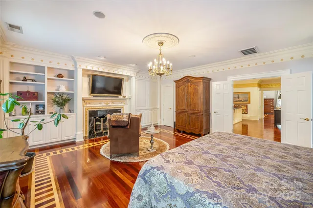 a spacious bedroom with a bed a couch and dresser