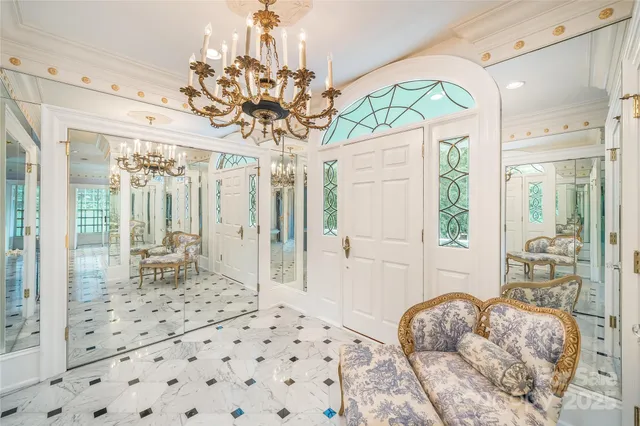 a view of a livingroom with furniture wooden floor chandelier