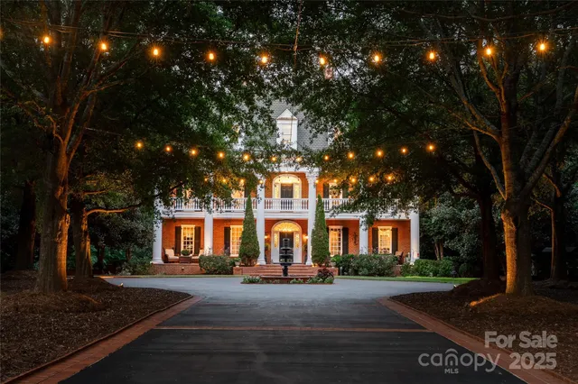 a view of a large trees in front of a house