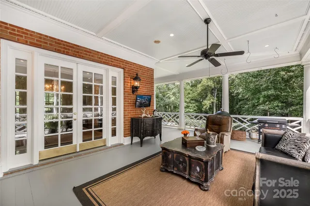 a living room with furniture and a floor to ceiling window