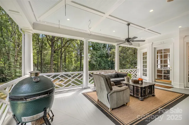 a work room with furniture and floor to ceiling windows