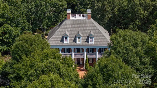 a aerial view of a house with a yard and balcony