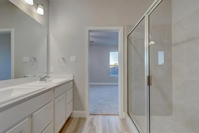 a bathroom with a sink double vanity and a mirror