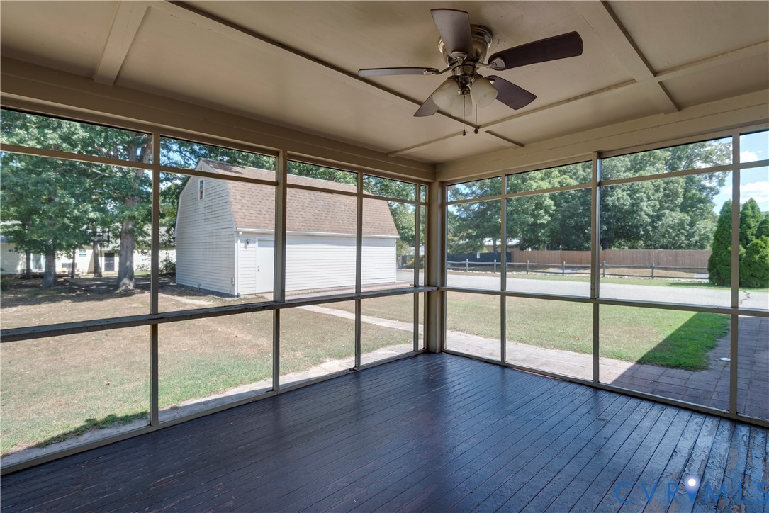 11600 Genito Road Midlothian, VA 23112 - Photo 28 of 42 a view of an empty room with wooden floor and a floor to ceiling window