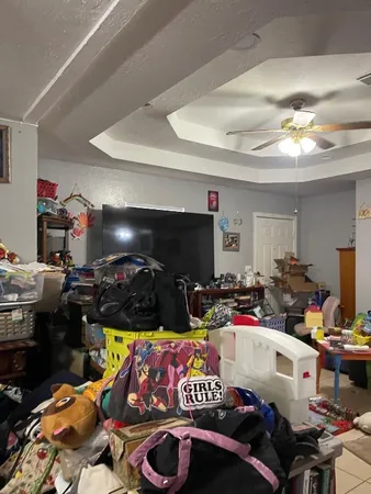 a bedroom with furniture and a flat screen tv