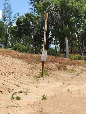 a wooden bench sitting in the middle of a yard