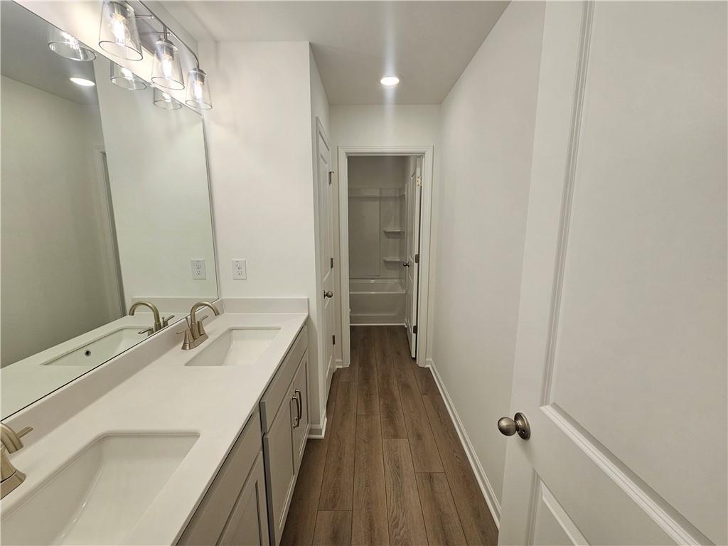 252 Silverleaf Trail Bethlehem, GA 30620 - Photo 13 of 31 a bathroom with a double vanity sink and a mirror