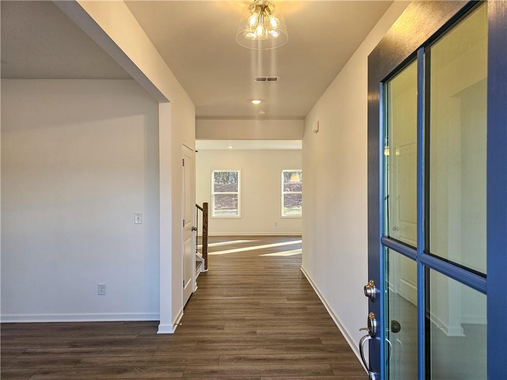 252 Silverleaf Trail Bethlehem, GA 30620 - Photo 2 of 31 a view of a hallway with wooden floor and staircase