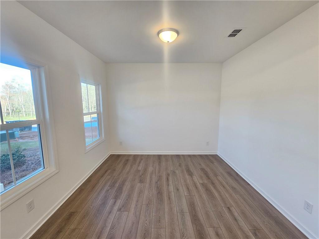252 Silverleaf Trail Bethlehem, GA 30620 - Photo 3 of 31 wooden floor in an empty room with a window