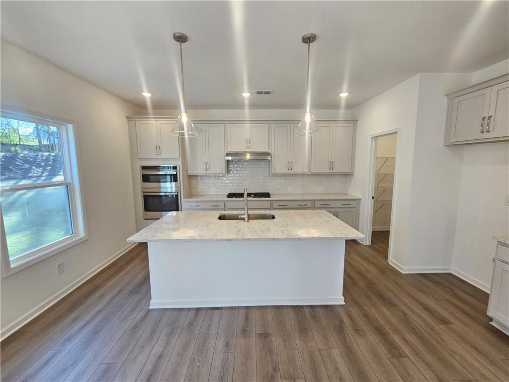 252 Silverleaf Trail Bethlehem, GA 30620 - Photo 4 of 31 a view of kitchen with cabinets and wooden floor