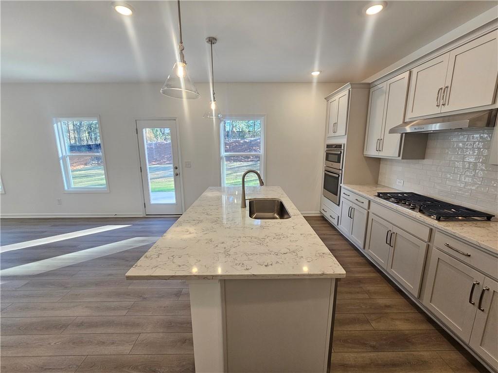 252 Silverleaf Trail Bethlehem, GA 30620 - Photo 5 of 31 a kitchen with a stove a sink and a refrigerator