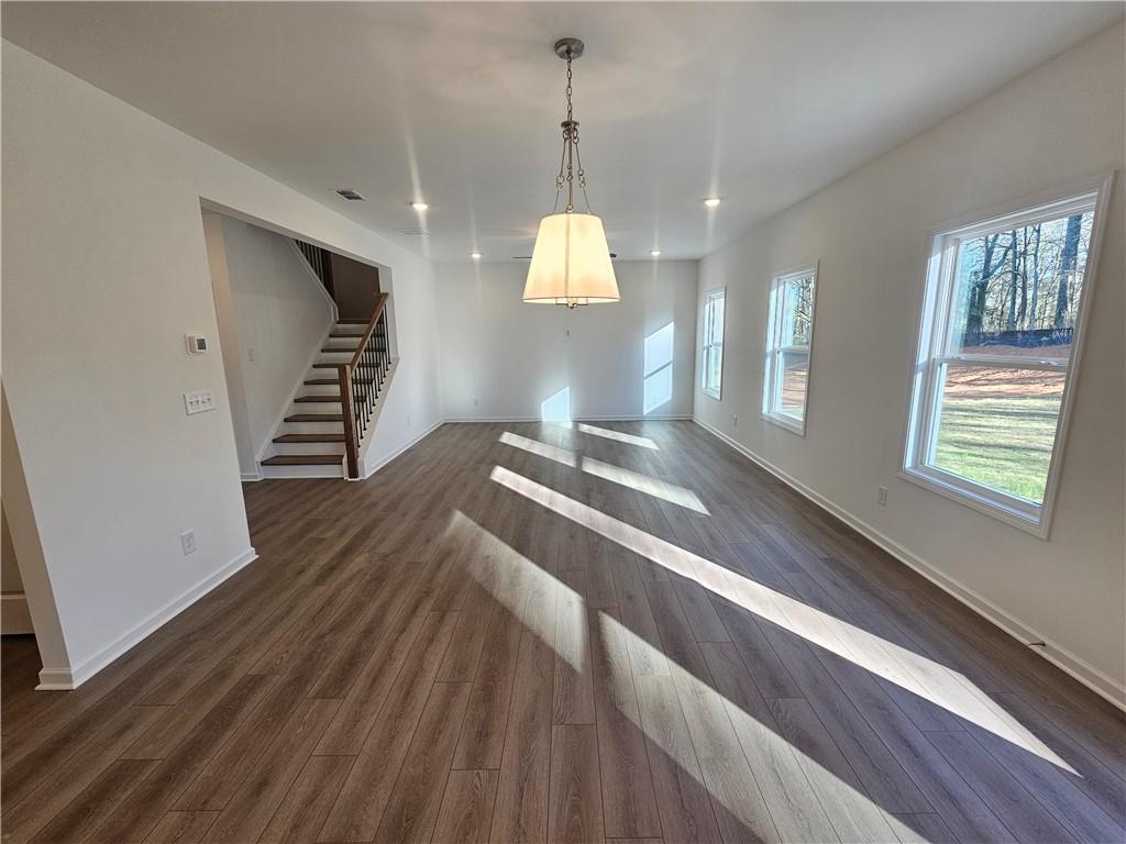 252 Silverleaf Trail Bethlehem, GA 30620 - Photo 7 of 31 a hallway with windows and a chandelier