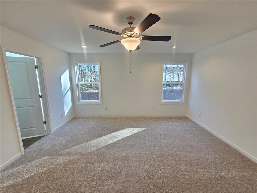 252 Silverleaf Trail Bethlehem, GA 30620 - Photo 10 of 31 an empty room with windows and fan