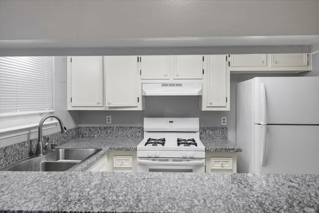 a kitchen with stainless steel appliances a refrigerator sink and cabinets